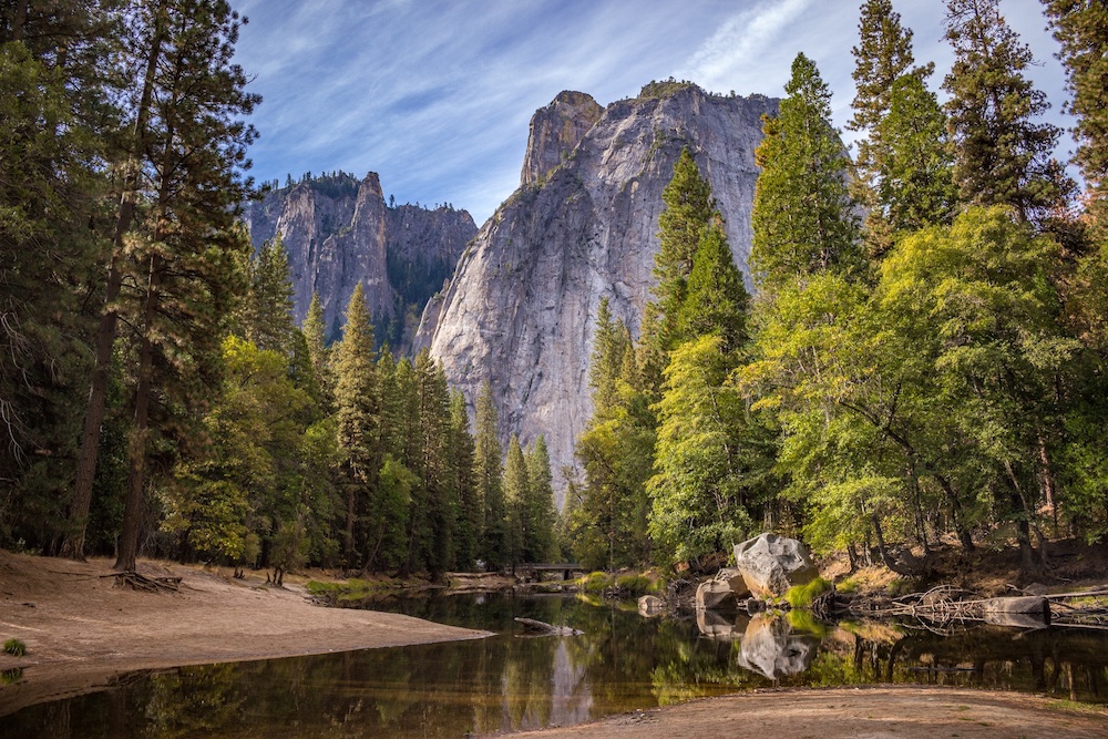 mountains are appearing behind trees