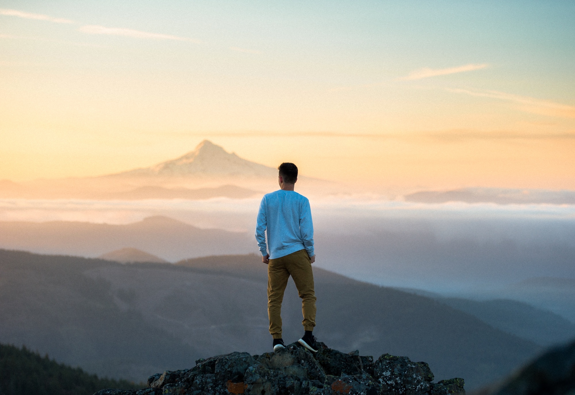 man standing on mountain cap